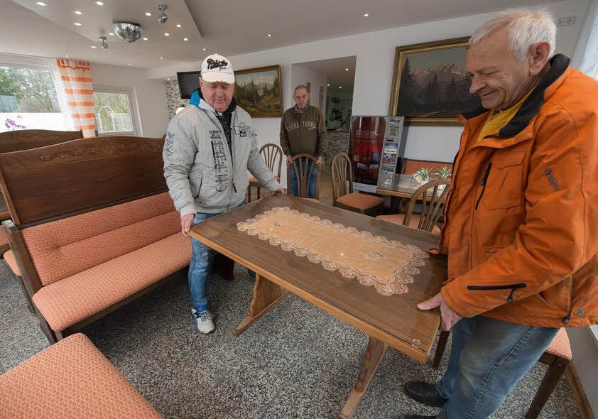 Der letzte Tisch wird aufgestellt. Nun können die Gäste wieder kommen.