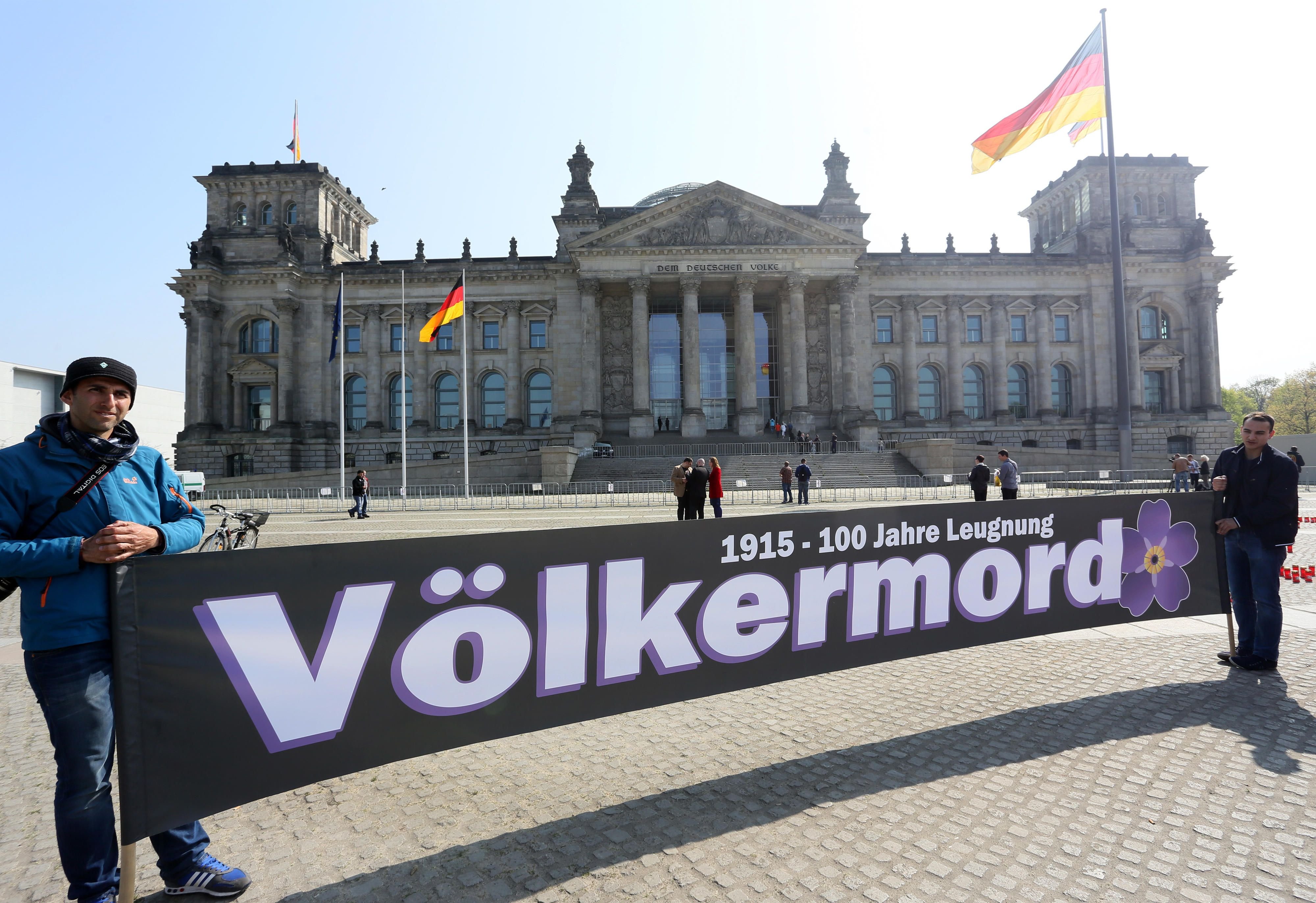 "Völkermord" ist auf dem Transparent zu lesen, das armenische Demonstranten am vor dem Reichstagsgebäude in Berlin halten.