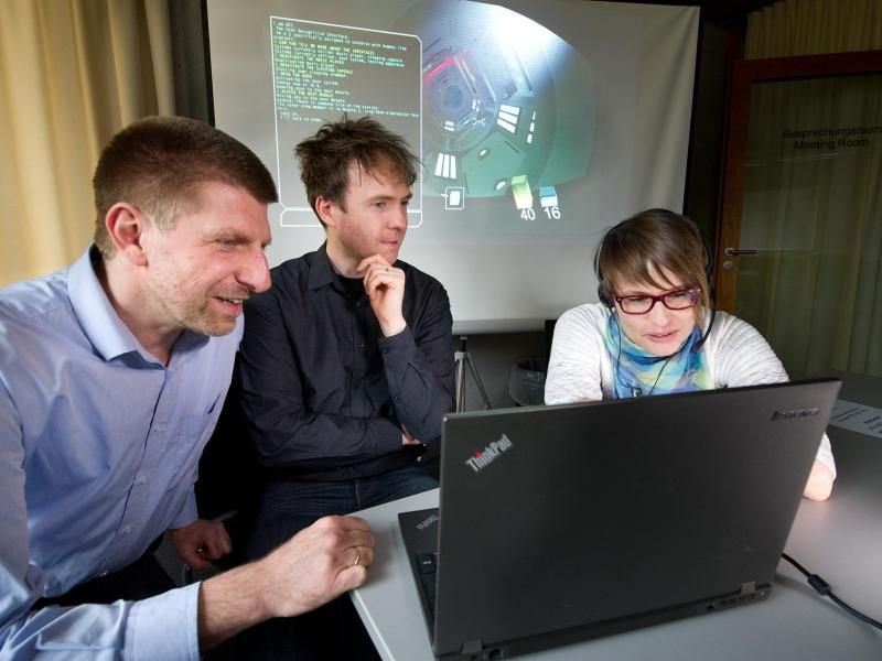 Professor Dieter Klakow (l) testet gemeinsam mit den Team-Mitarbeitern Thomas Kleinbauer und Anna Schmidt das Weltraum-Computertspiel „Sonar Silence“ (undatierte Aufnahme). Foto: Iris Maurer