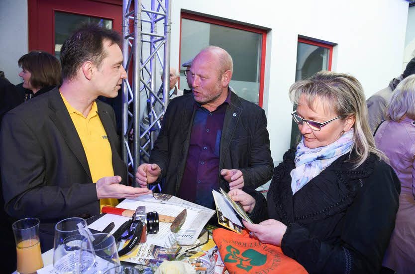 Heiko Kern zeigt Jana Grandi, Unstruttal-Verbandsgemeindebürgermeisterin, und Karsdorfs Bürgermeister Olaf Schumann Fotos aus zehn Jahren Vereinsgeschichte.