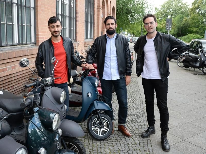 Die Unu-Gründer Elias Atahi (l-r), Mathieu Caudal und Pascal Blum wollen im Februar kommenden Jahres einen E-Roller auf den Markt bringen, der über eine SIM-Karte vernetzt ist. Foto: Jens Kalaene
