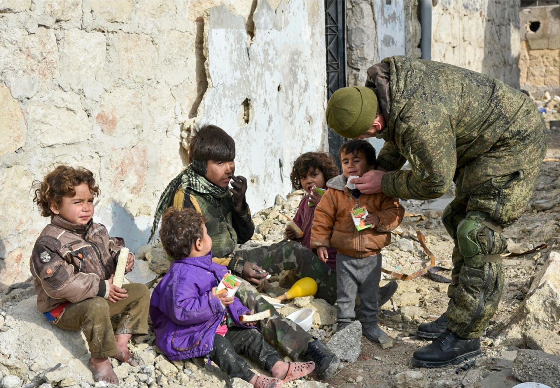 Aleppo, Syrien, März 2017: Ein undatiertes Handout des russischen Verteidigungsministeriums zeigt nach russischen Angaben einen Soldaten der russischen Armee, der in Aleppo Saft an Kinder verteilt.
