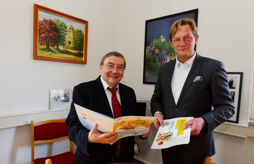 Michael Heinemann (links) und Tobias Voigt blättern in Katalogen, in denen die Produkte der Lebensmittelbetriebe vorgestellt werden.