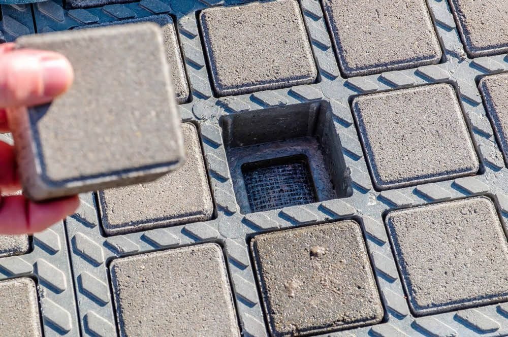 So funktioniert es: In die Gitterplatten aus Kunststoff werden Pflastersteine verlegt. Dazwischen ist genug Platz zum Versickern von Wasser.