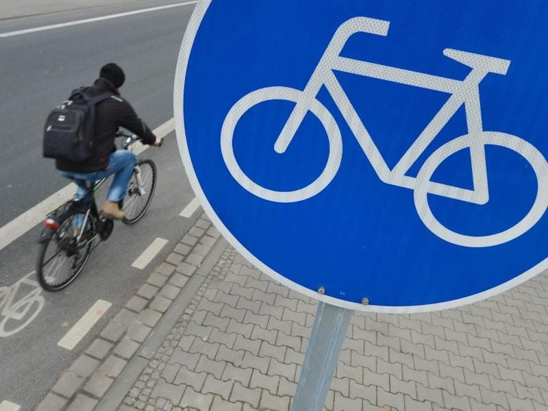 Ein Mann fährt mit seinem Fahrrad auf einem Radweg. Foto: Arne Dedert/Archiv