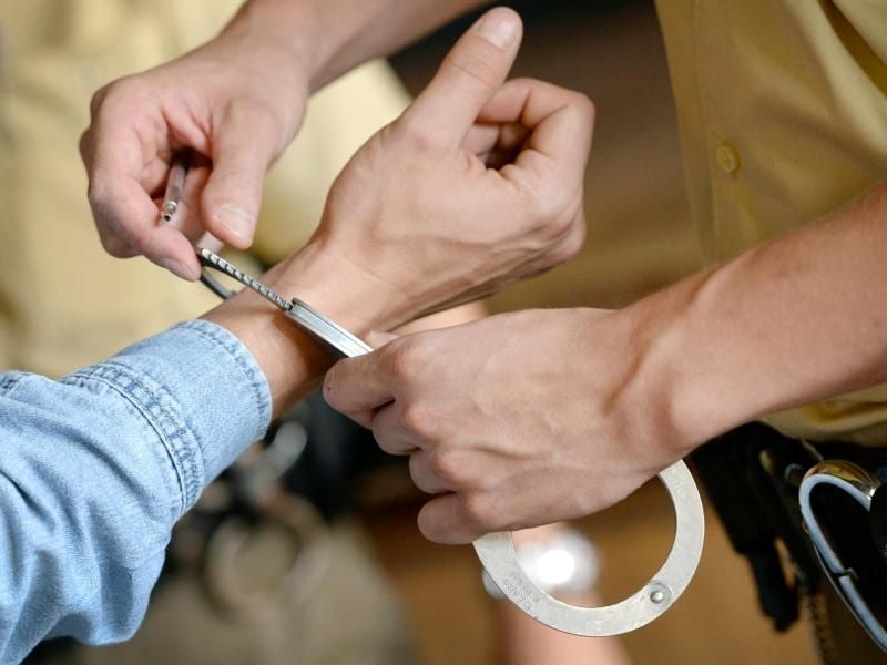 Einer Person werden Handschellen angelegt. Foto: Andreas Gebert/Archiv