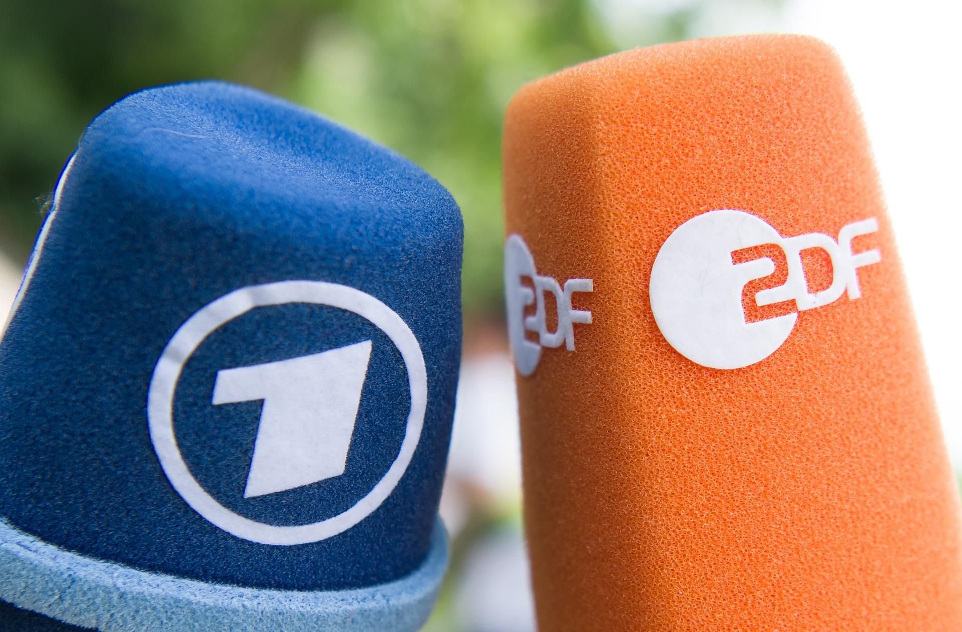 Illustration: Mikrofone mit den Logos von ARD und ZDF