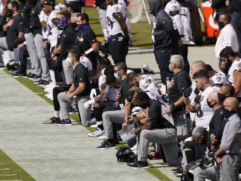 Die Baltimore Ravens knien während der Nationalhymne. Foto: Susan Walsh/AP/dpa