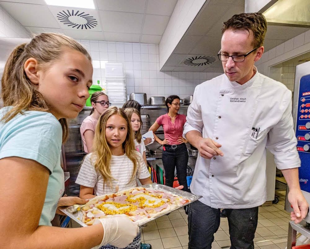 Lilly und Jasmin (links) haben auf dem Pizzablech ihre Initialen verewigt. Christian Hirsch, Küchendirektor des Lutherhotels, kocht in diesen Ferien mal mit Kindern. Es ist ein Angebot aus dem neuen „Kinderferienerlebnispass“.