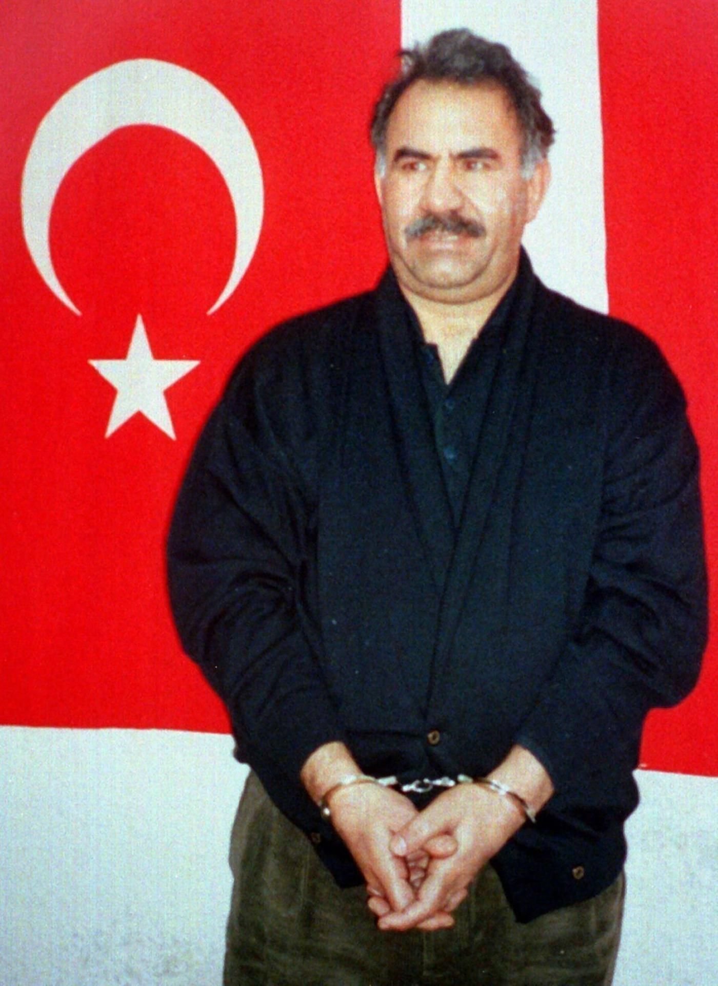 Der ehemalige PKK-Chef Abdullah Öcalan steht in Handschellen vor einer türkischen Flagge auf der türkischen Gefängnis-Insel Imrali.
