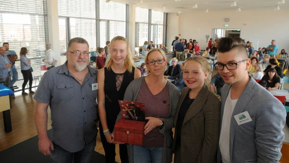 Zum Tag der offenen Tür in der Freien Schule „Jan Hus“ erhält Corinna Cyliax (M.) Spenden aus dem Erlös der Musical-Aufführungen überreicht.