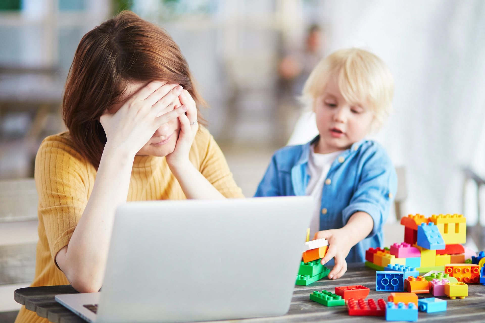 Die Konzentration lässt schnell nach, wenn das Kind nebenan mit Lego spielt, während Frau im Homeoffice sitzt (Symbolbild).