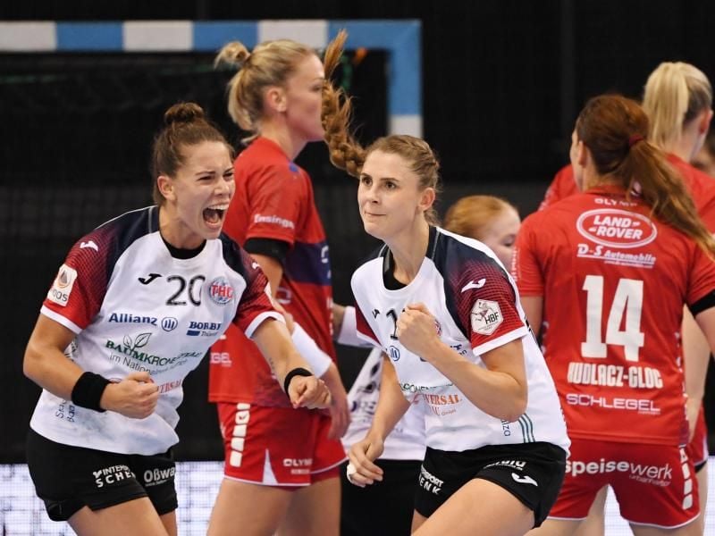 Emily Bölk (l) und Alicia Stolle (M) vom Thüringer HC jubeln nach einem wichtigen Tor. Foto: Marijan Murat