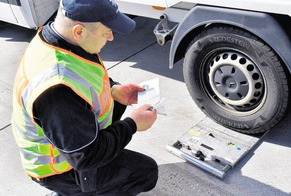 Polizeihauptmeister Wilfried Krischkern überprüft bei einem Wohnmobil die Fahrzeugpapiere und das Gesamtgewicht.