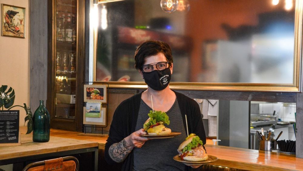 Die Inhaberin von „Wittenburger“ Lydia Grauss überreicht ihren Gästen saftige Burger.