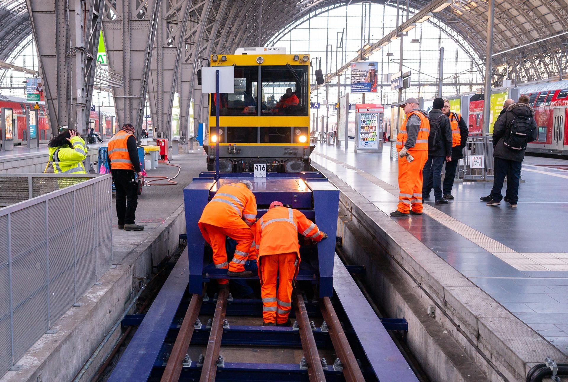 Mitarbeiter der Deutschen Bahn AG reparieren den beschädigten Prellbock.