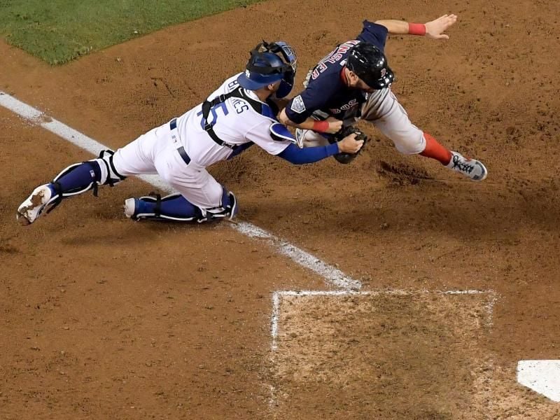 Los Angeles Dodgers Catcher Austin Barnes (l) versucht Ian Kinsler von den Boston Red Sox während des 10. Innings festzuhalten. Foto: Mark J. Terrill/AP