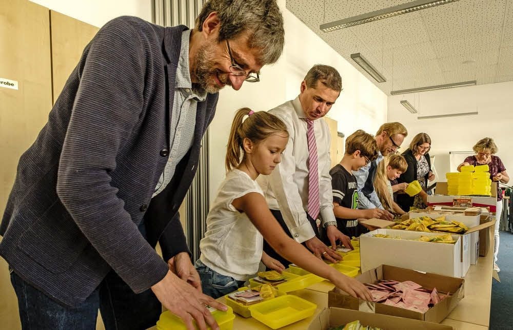 Ähnlich wie an einem Fließband bestücken Helfer die Brotbüchsen für die Schulanfänger im Landkreis mit Bio-Lebensmitteln.