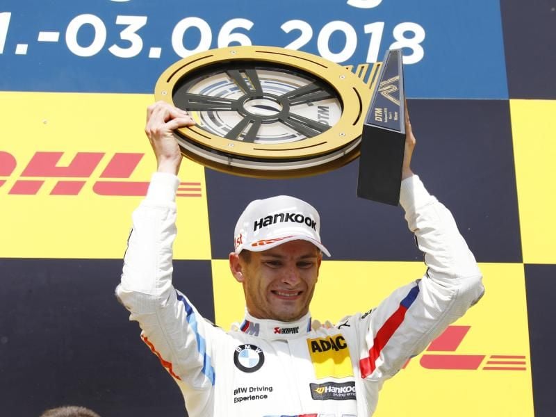 Marco Wittmann aus Deutschland vom Team BMW Team RMG jubelt nach dem Sieg auf dem Siegerpodest. Foto: Juergen Tap/Hoch Zwei/DTM/ITR