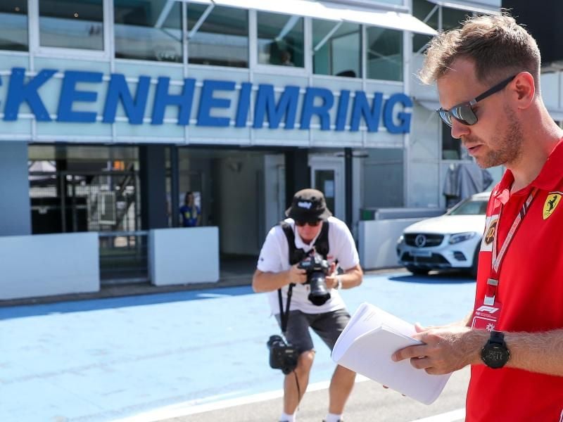 Sebastian Vettel geht über die Rennstrecke des Hockenheimrings. Foto: Jan Woitas
