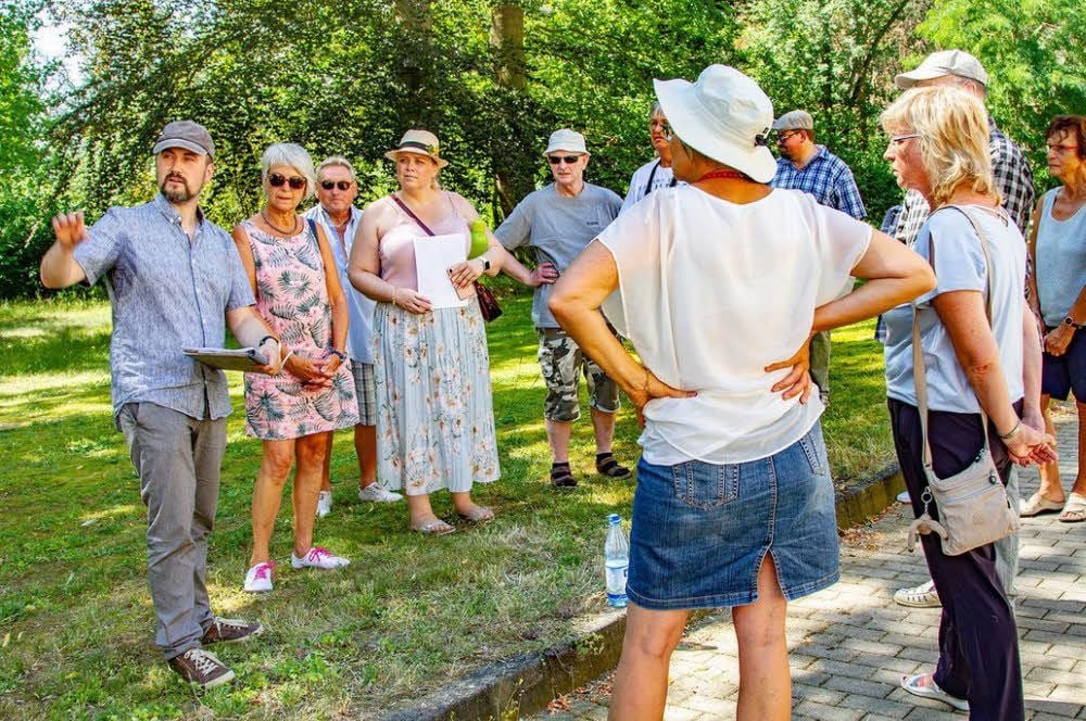 Benny Berger (l.) führt eine Gruppe von Interessenten durch die Überreste des ehemaligen Krankenhauses in Carlsfeld.