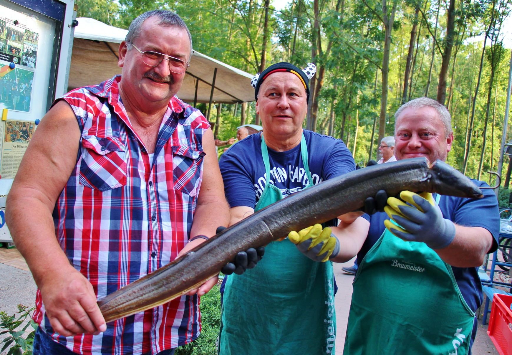 Das größte Stück im Räucherschrank: Ein 1,05 Meter langer Aal, den Frank Nowotnig (vorn, links), Peter Machura und Ulrich Schiller präsentierten.