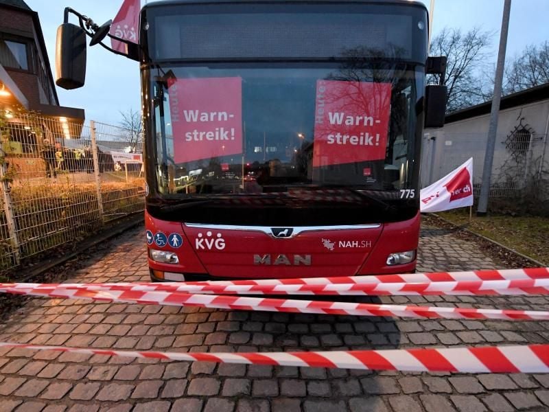 Ein Bus der Kieler Verkehrs Gesellschaft (KVG) mit Streik-Plakaten. Foto: Carsten Rehder/dpa