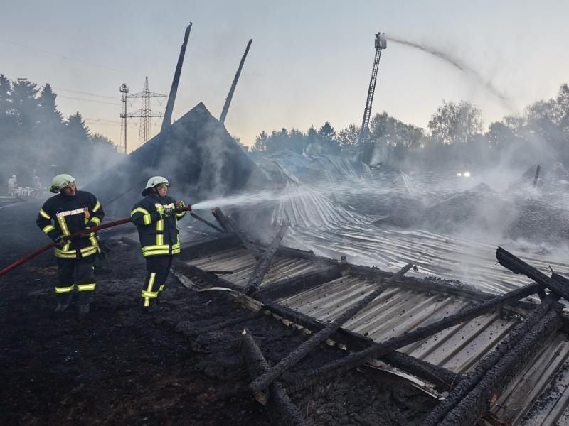 Feuerwehrleute bekämpfen den Brand in einer Tennishalle in Quickborn. Foto: Georg Wendt