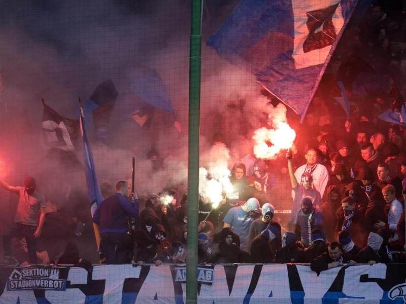 Fans des Hamburger SV zünden Pyrotechnik im Stadion. Foto: Axel Heimken/dpa/Archivbild