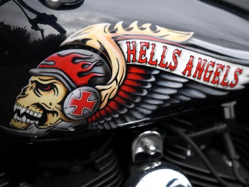 Das Hells Angels-Emblem, ein Totenkopf mit Helm und Flügeln, auf einem Tank eines abgestellten Motorrads. Foto: picture alliance / Arne Dedert/dpa