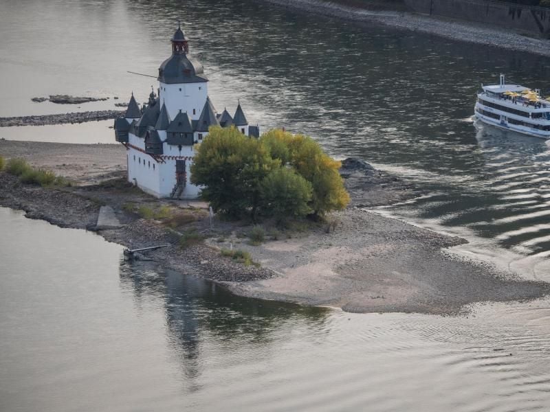 Ein Ausflugsschiff fährt bei Niedrigwasser rund um die Burg Pfalzgrafenstein an Sandbänken vorbei. Foto: Boris Roessler/Archiv