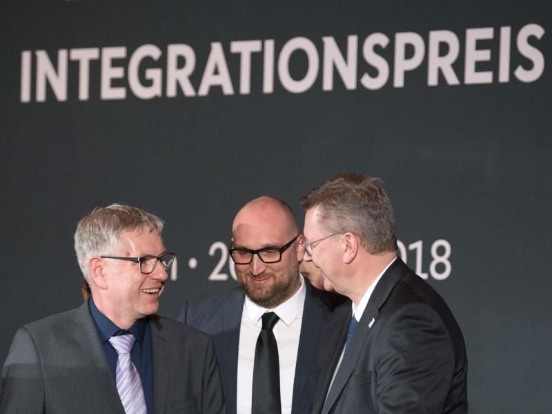 DFB-Präsident Reinhard Grindel (r) verleiht den Integrationspreis in der Kategorie Schule - der geht nach Herne. Foto: Soeren Stache