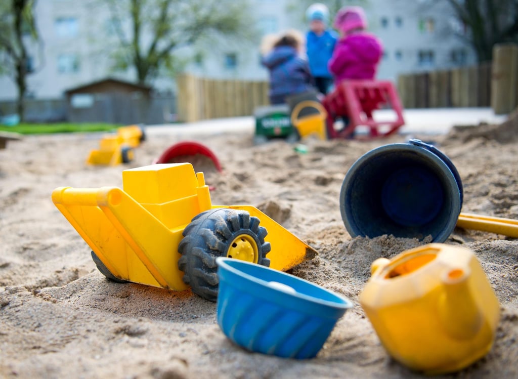 Spielzeug an einem Sandkasten einer Kindertagesstätte.