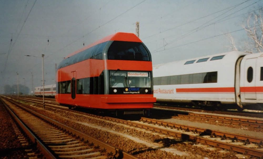 Zum Größenvergleich: 1995 wird der Prototyp vom Doppelstock-Schienenbus nahe des Bahnhofes Magdeburg von einem ICE überholt.