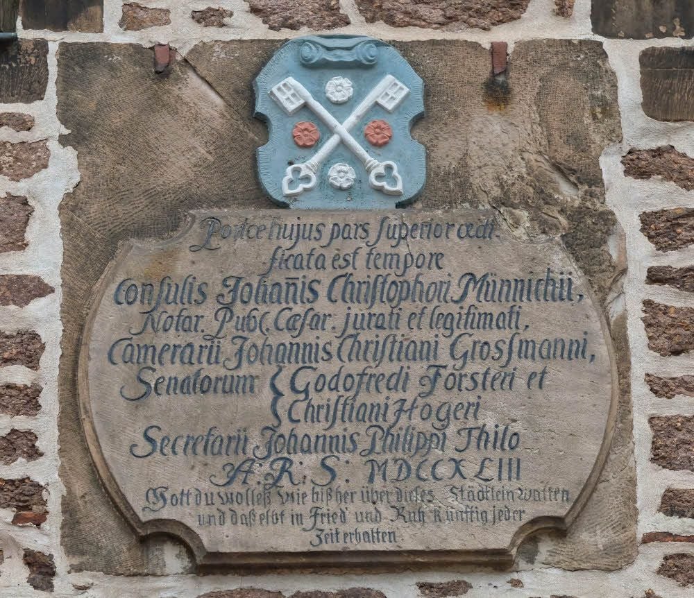 Die Inschrift befindet sich über dem Torbogen.