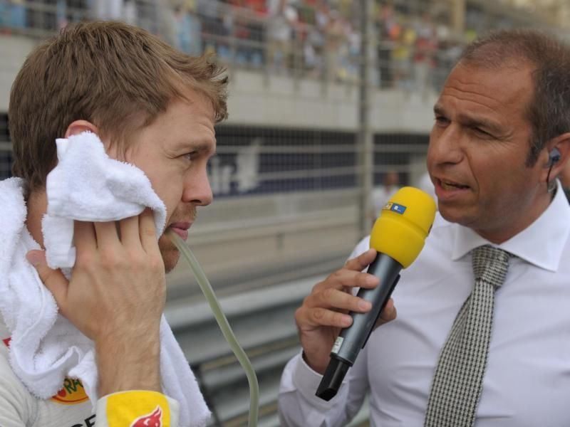 Formel-1-Pilot Sebastian Vettel (l) spricht mit dem TV-Moderator Kai Ebel von RTL. Foto: David Ebener