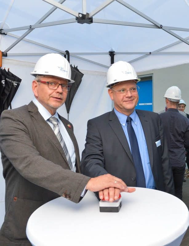 Oberbürgermeister Bernd Hauschild und Maik Erbert (r.) vollziehen den symbolischen Knopfdruck.