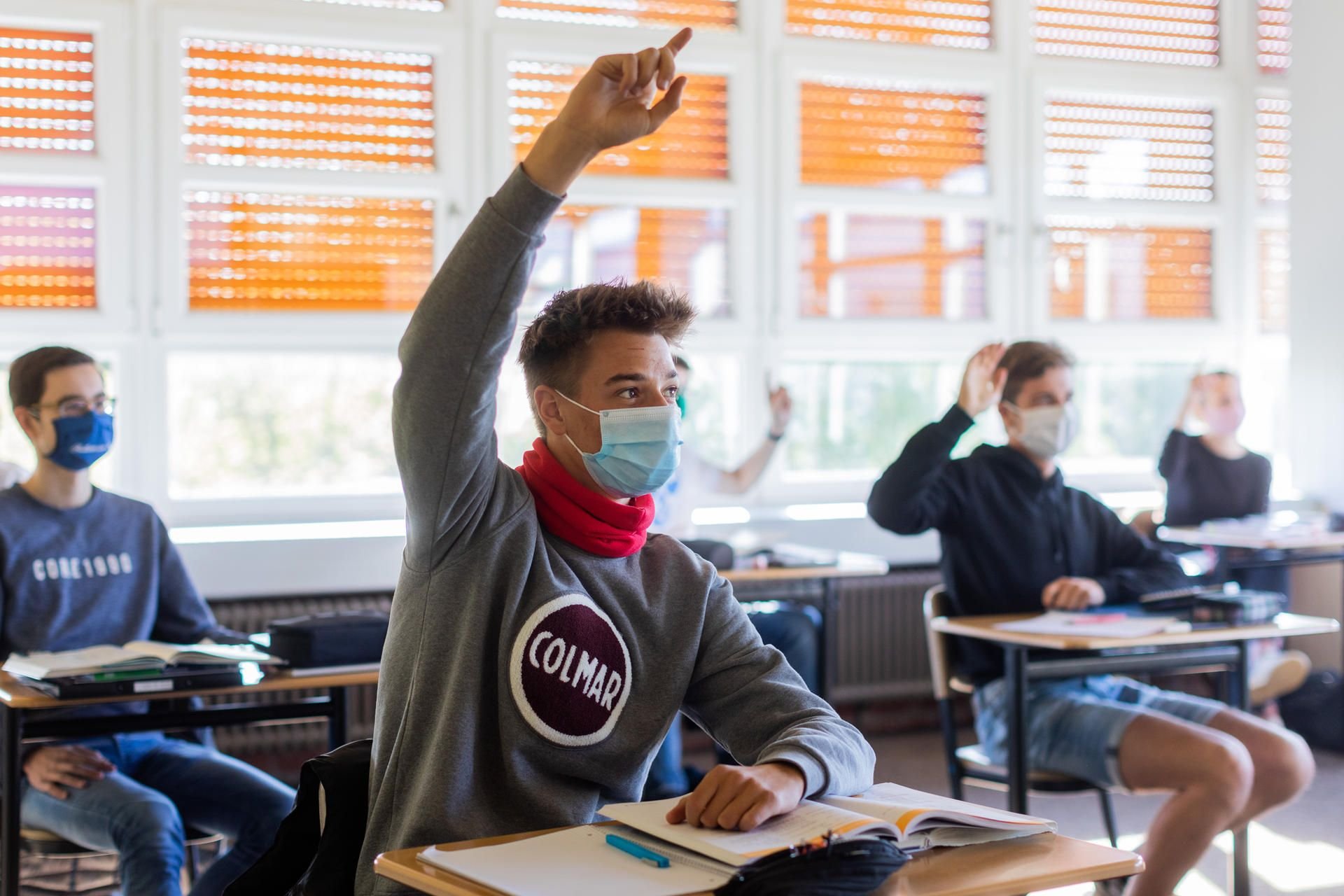 Schülerinnen und Schüler des Abiturjahrgangs 2020 sitzen in ihrem Kursraum.