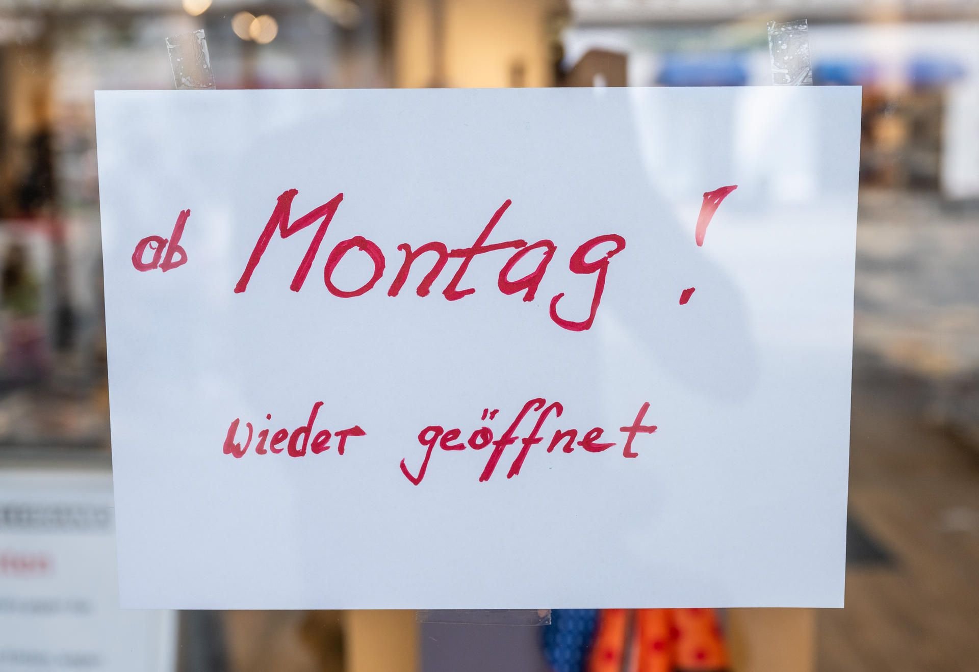 „Ab Montag! Wieder geöffnet“, steht auf einem Zettel an der Tür eines Ladens.