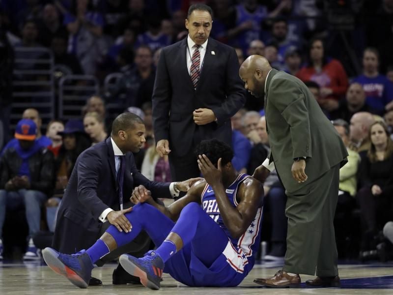 Joel Embiid (sitzend) zog sich beim Sieg seiner 76ers gegen die New York Knicks einen Jochbeinbruch am linken Auge zu. Foto: Matt Slocum