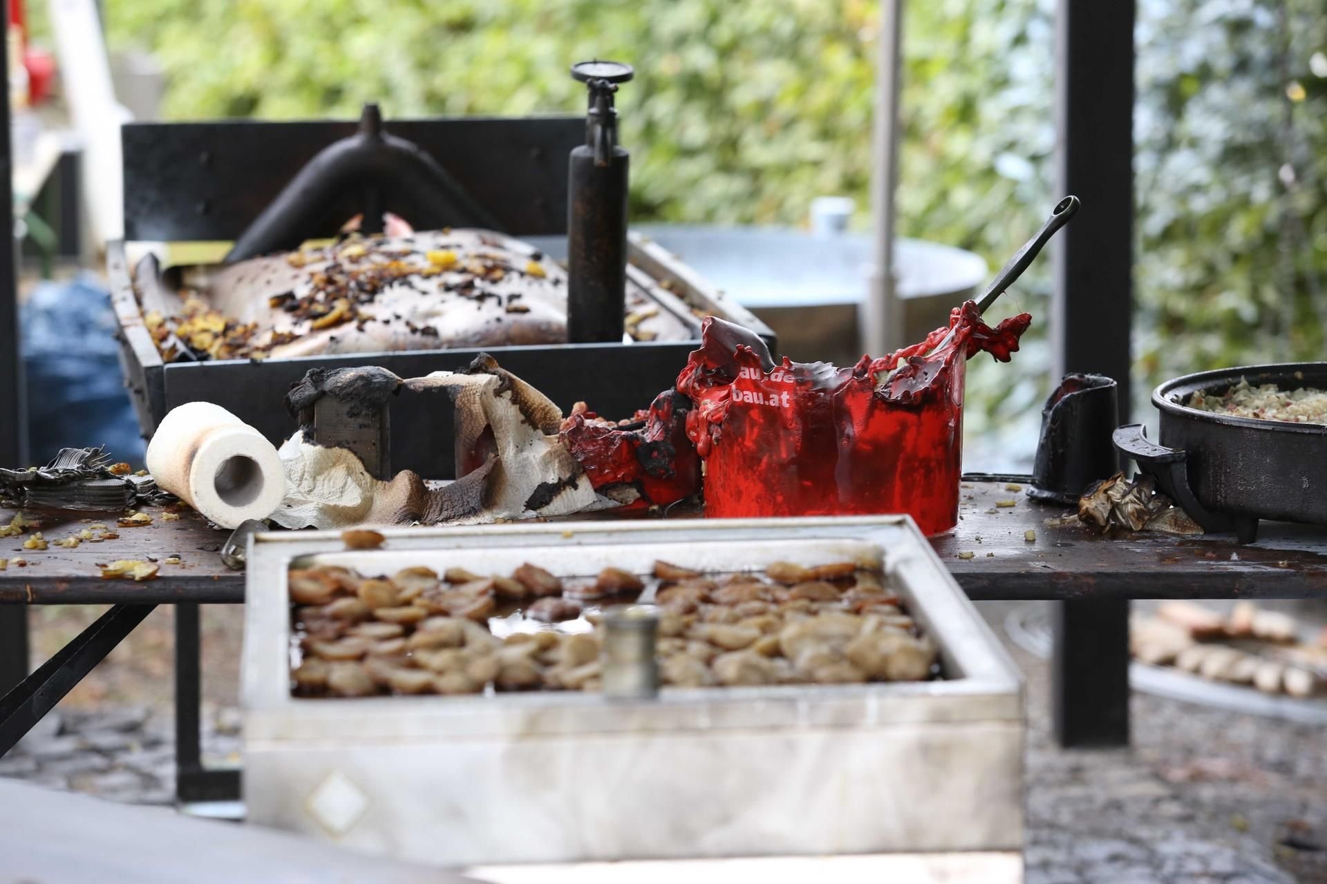 Verbrannte Grill-Utensilien sind auf dem Gelände eines Brauchtumsfestes im Siegerland zu sehen.