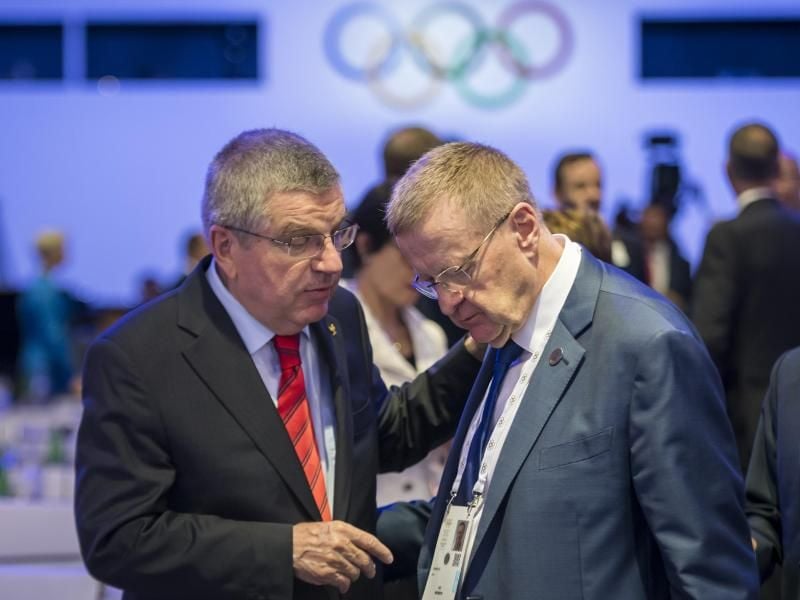 IOC-Präsident Thomas Bach (l) spricht mit John Coates, IOC-Mitglied aus Australien. Foto: Jean-Christophe Bott/KEYSTONE