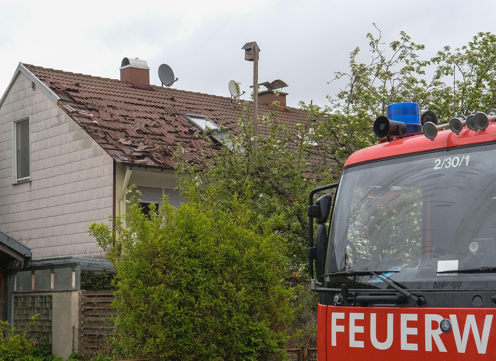 Kaufbeuren: Ein Feuerwehrfahrzeug steht an der Einsatzstelle vor einen beschädigten Haus.