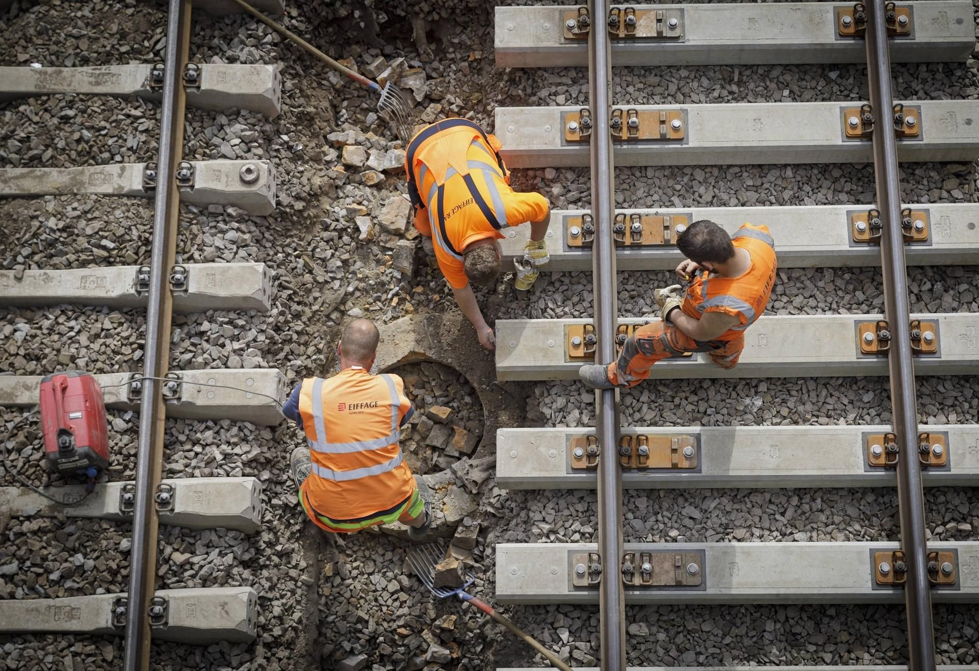 Illustration: Bauarbeiter sind an einer neu angelegten Gleisanlage der Bahn beschäftigt.