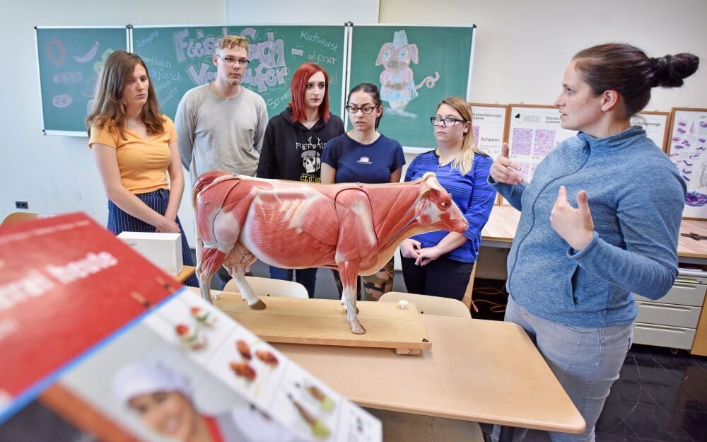 Praxislehrkraft Tina Wehle (r.) erklärt beim letztjährigen Herbstfest des Bitterfelder Berufsschulzentrums den Job des Fleischfachverkäufers.
