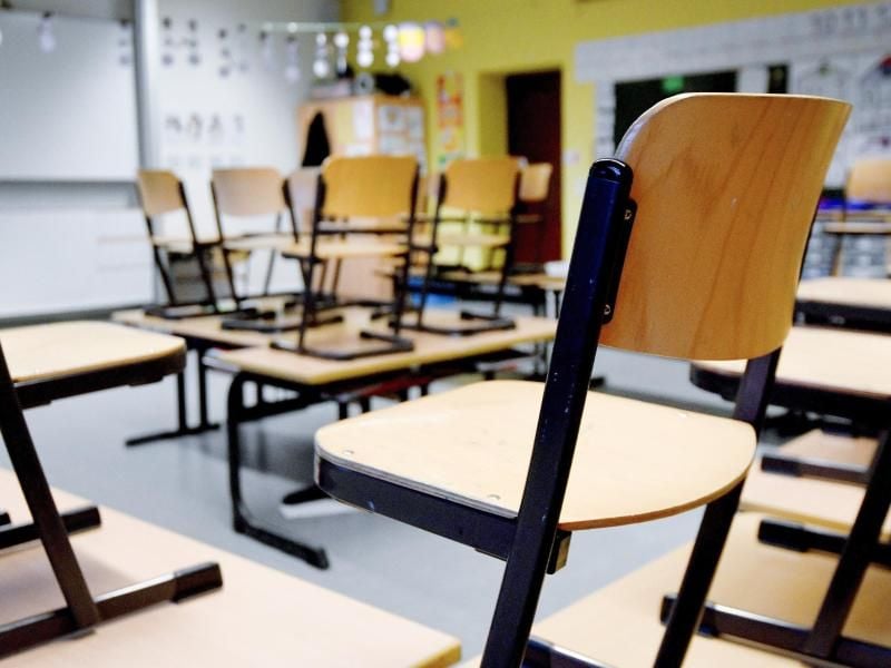 Stühle stehen in einem Klassenzimmer in einer Grundschule auf den Tischen. Foto: Caroline Seidel/dpa/Symbolbild