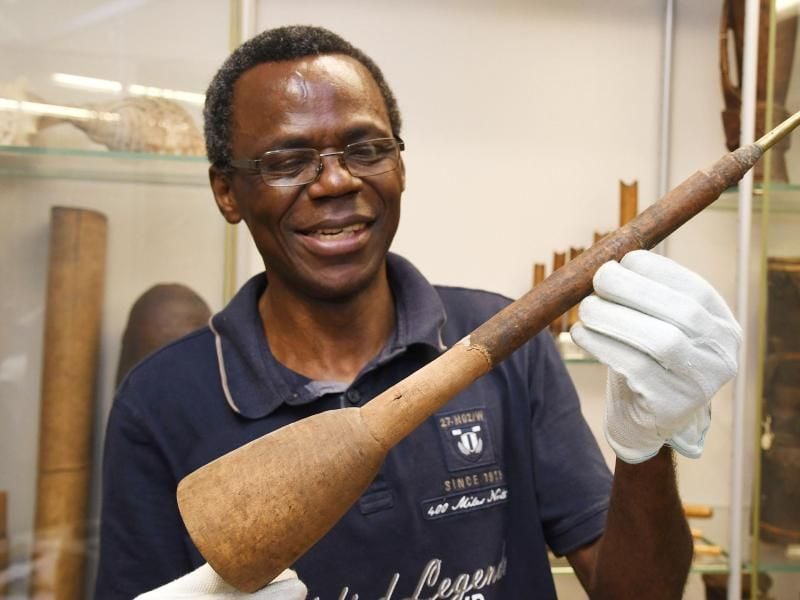 Der Wissenschaftler Ndzodo Awono zeigt im Übersee-Museum eine Schalmai aus Kamerun. Er fasst den Bestand von Objekten aus der Sammlung aus Kamerun zusammen. Foto: Carmen Jaspersen