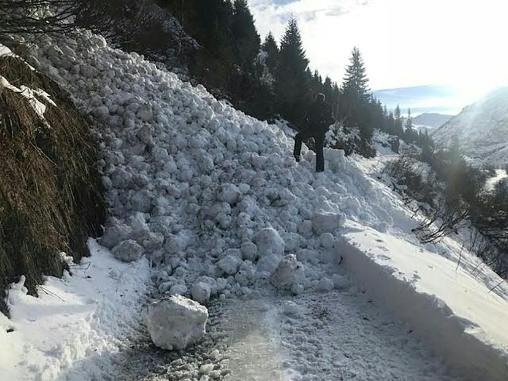 Eine Schneelawine versperrt den Weg auf einer österreichischen Straße. (Symbolbild)