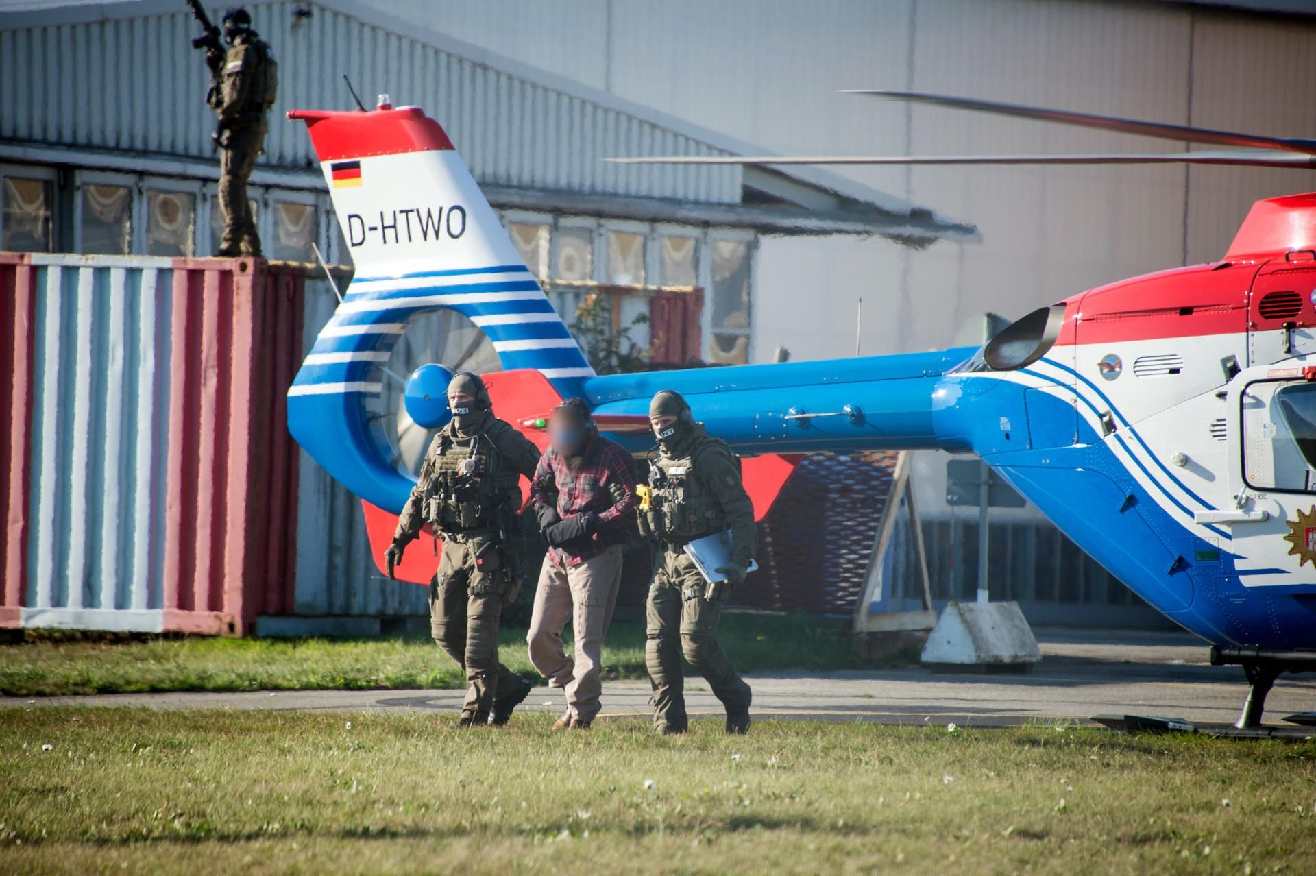 Der Terror-Helfer Mounir el Motassadeq (M.) wird von Polizeibeamten aus einem Hubschrauber am Geschäftsfliegerzentrum geführt. Nach fast 15 Jahren Haft ist der 9/11-Terrorhelfer Mounir el Motassadeq am Montag von einem Hubschrauber aus der Justizvollzugsanstalt Fuhlsbüttel abgeholt worden.