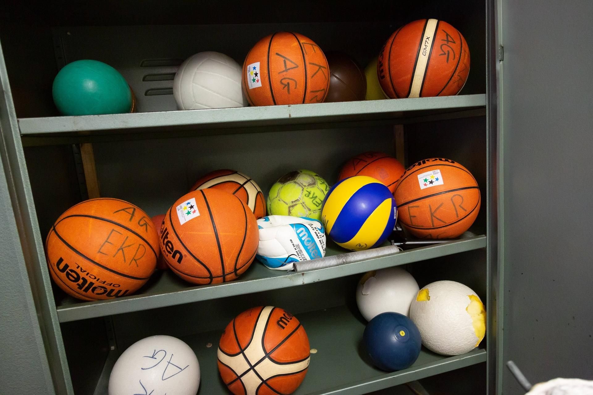 Bälle verschiedener Sportarten in einem Schrank für den Sportunterricht